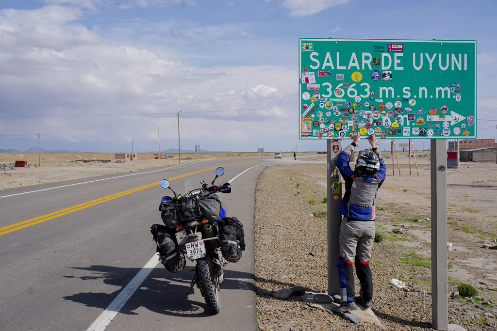 Adding our JUST A MOTORIDE sticker to the Salar signpost